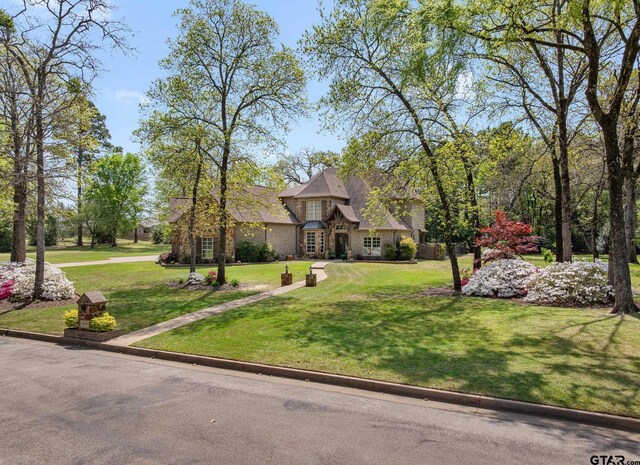 5875 Stonegate Trl, Tyler, TX 75703 - view of front of house with a front lawn and stone siding