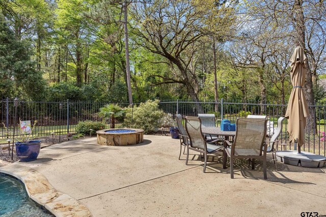 5875 Stonegate Trl, Tyler, TX 75703 - view of patio / terrace featuring fence, outdoor dining area, and a fire pit