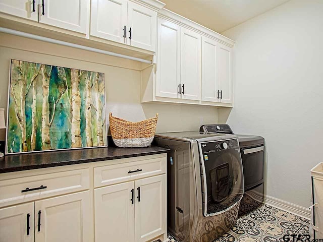 clothes washing area with cabinets, light tile patterned floors, and independent washer and dryer