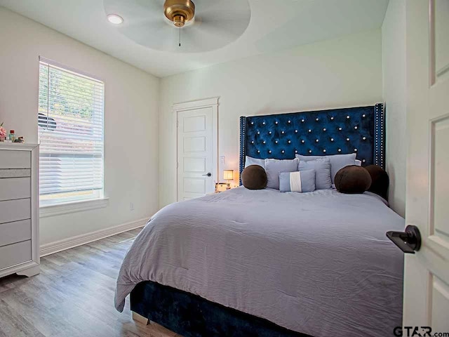 bedroom featuring hardwood / wood-style flooring and ceiling fan