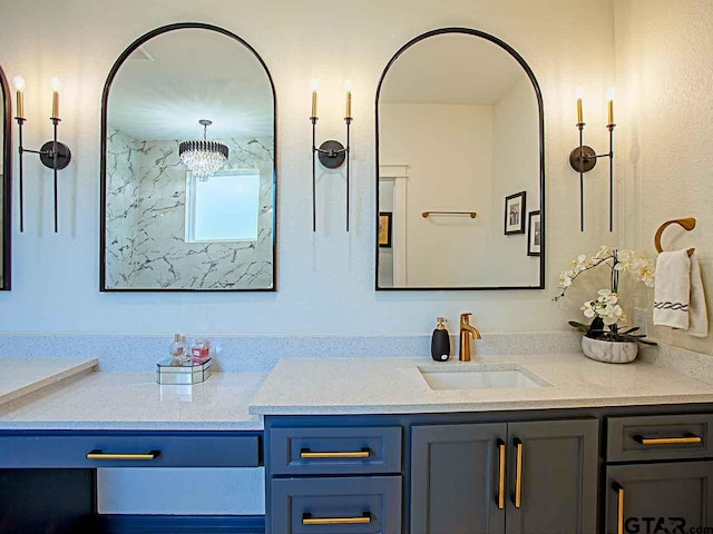 bathroom with vanity and a chandelier