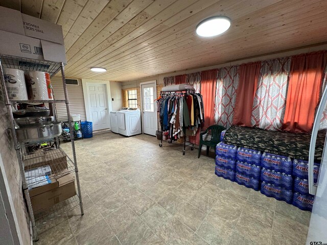 laundry area with washing machine and clothes dryer and wood ceiling