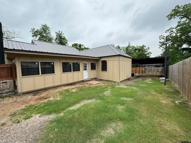 rear view of property with a yard