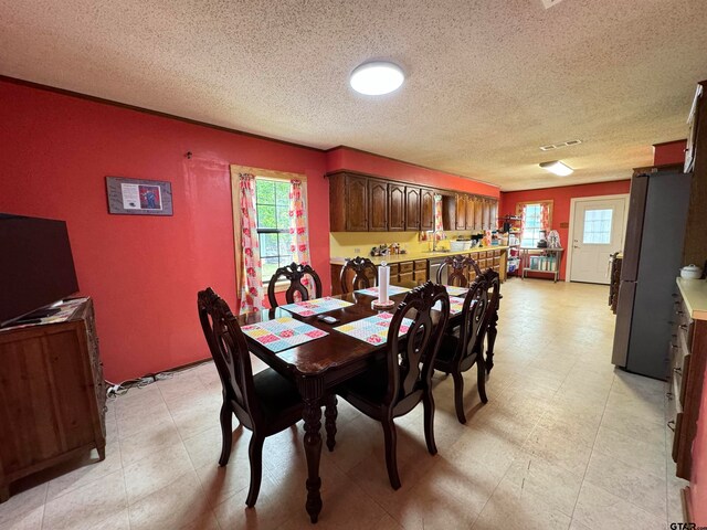 dining space with a textured ceiling