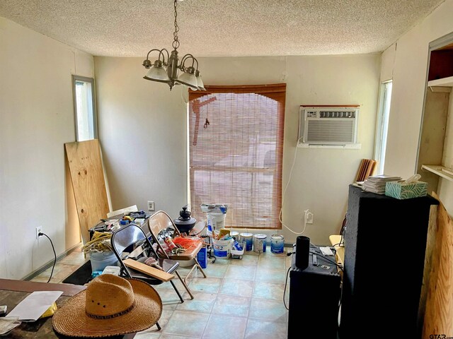 11011 Fm 2767, Tyler, TX 75708 - dining space with an AC wall unit, a textured ceiling, and an inviting chandelier