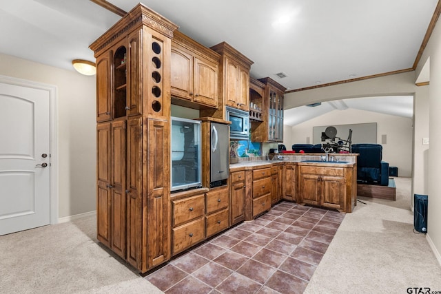 1516 Chaparrel Run, Tyler, TX 75703 - kitchen featuring stainless steel microwave, a peninsula, glass insert cabinets, dark colored carpet, and crown molding