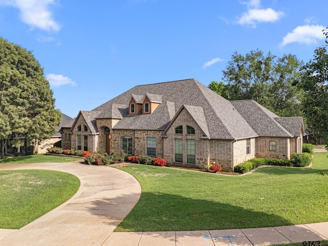 1516 Chaparrel Run, Tyler, TX 75703 - french country inspired facade featuring brick siding, a front lawn, and a shingled roof