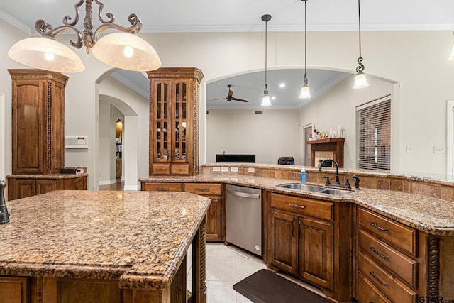1516 Chaparrel Run, Tyler, TX 75703 - kitchen featuring dishwasher, a sink, crown molding, light stone counters, and arched walkways