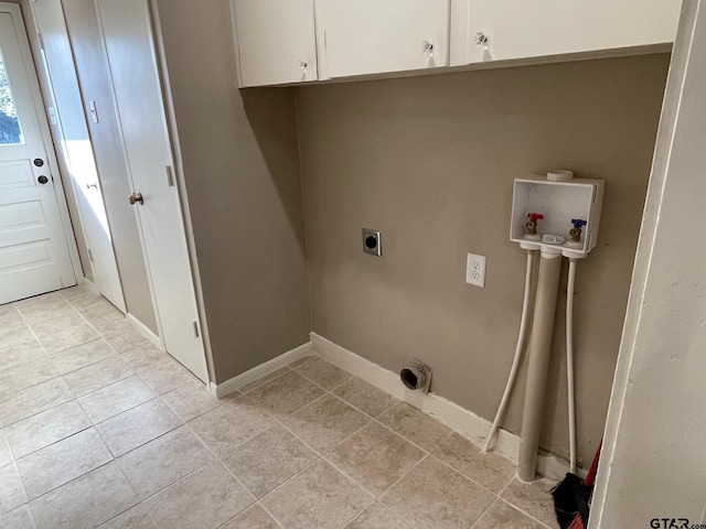 laundry area featuring hookup for an electric dryer, hookup for a washing machine, cabinets, and light tile patterned flooring