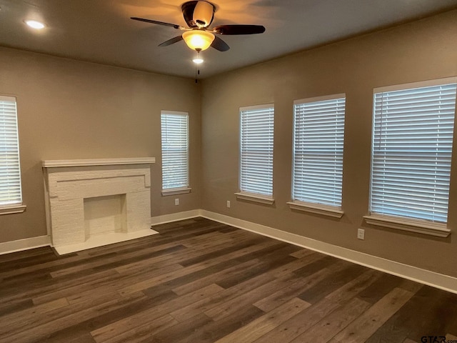 unfurnished living room with a healthy amount of sunlight and dark hardwood / wood-style flooring