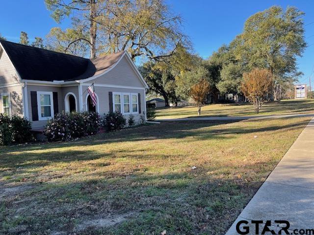 view of property exterior with a lawn