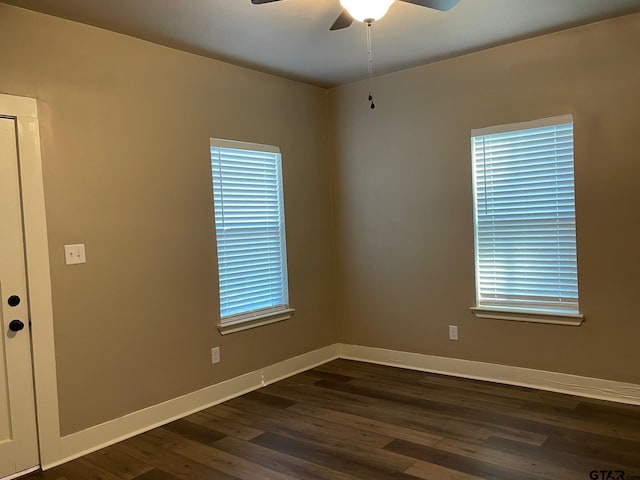 spare room with dark hardwood / wood-style floors, plenty of natural light, and ceiling fan