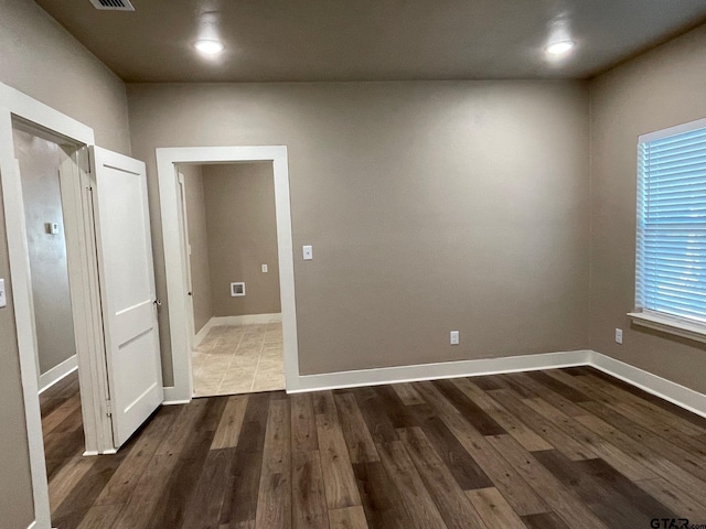 spare room featuring dark hardwood / wood-style floors