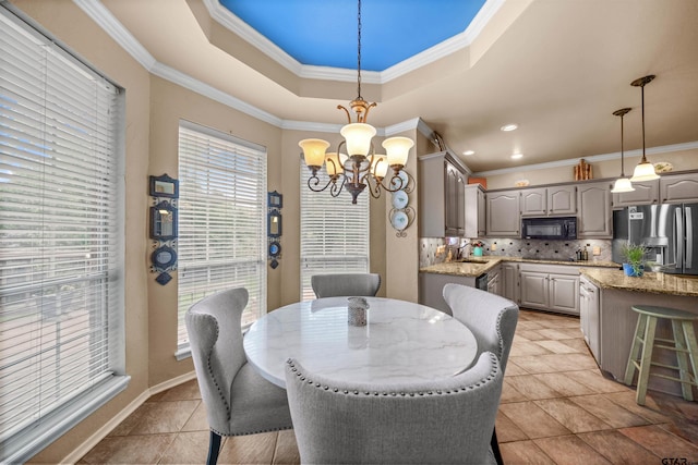 1408 Santa Fe Trl, Tyler, TX 75703 - dining room with a chandelier, plenty of natural light, ornamental molding, a tray ceiling, and light tile patterned floors