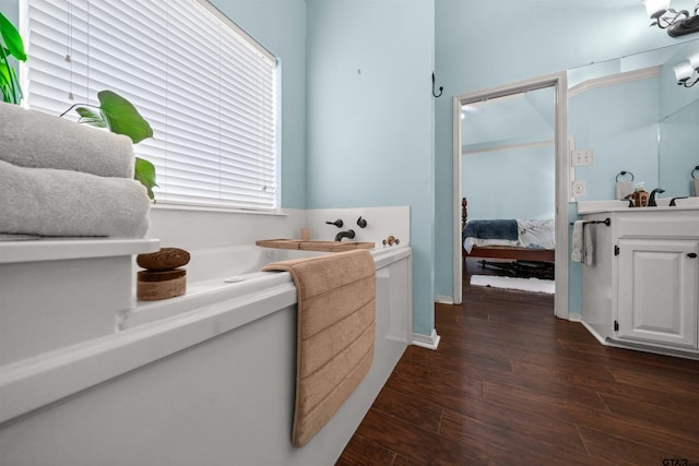 1408 Santa Fe Trl, Tyler, TX 75703 - bathroom featuring ensuite bath, wood finished floors, a bath, and vanity