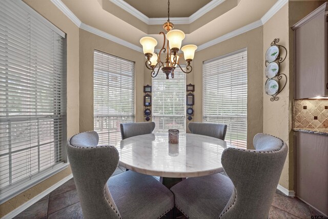 1408 Santa Fe Trl, Tyler, TX 75703 - dining room featuring a raised ceiling, a chandelier, ornamental molding, and baseboards