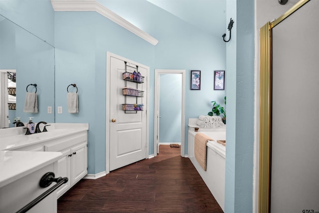 1408 Santa Fe Trl, Tyler, TX 75703 - bathroom with wood finished floors, a bath, vanity, vaulted ceiling, and baseboards
