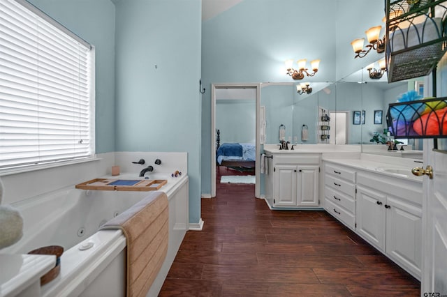 1408 Santa Fe Trl, Tyler, TX 75703 - ensuite bathroom featuring double vanity, wood finished floors, a jetted tub, and a chandelier