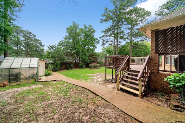 1408 Santa Fe Trl, Tyler, TX 75703 - view of yard with an exterior structure, a wooden deck, and an outdoor structure