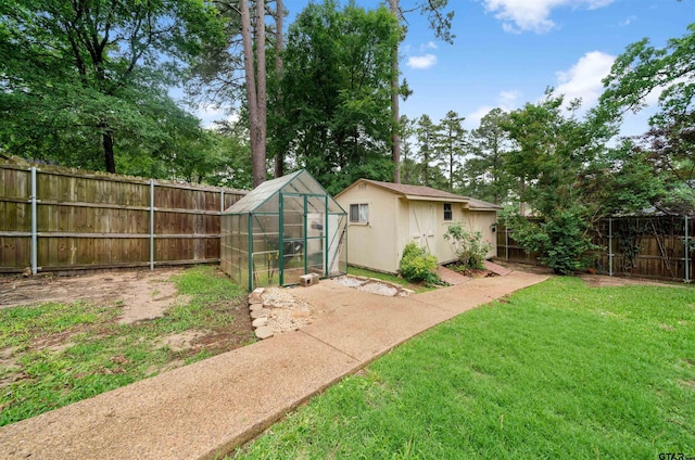 1408 Santa Fe Trl, Tyler, TX 75703 - view of yard featuring an outbuilding, a greenhouse, and a storage unit