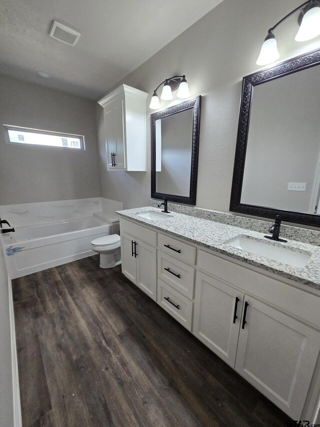 508 Cornerstone, Lindale, TX 75771 - full bath featuring visible vents, wood finished floors, a tub, and a sink