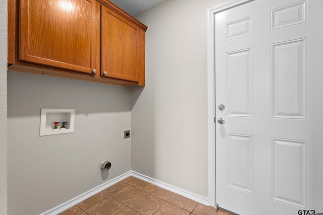 washroom featuring hookup for a washing machine, cabinets, hookup for an electric dryer, and light tile patterned flooring