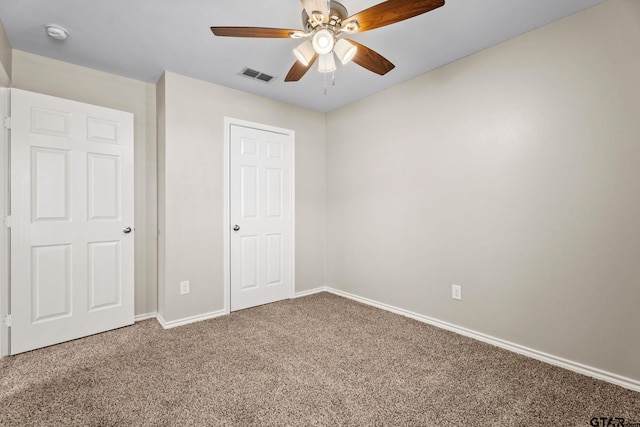 unfurnished bedroom featuring ceiling fan and carpet flooring