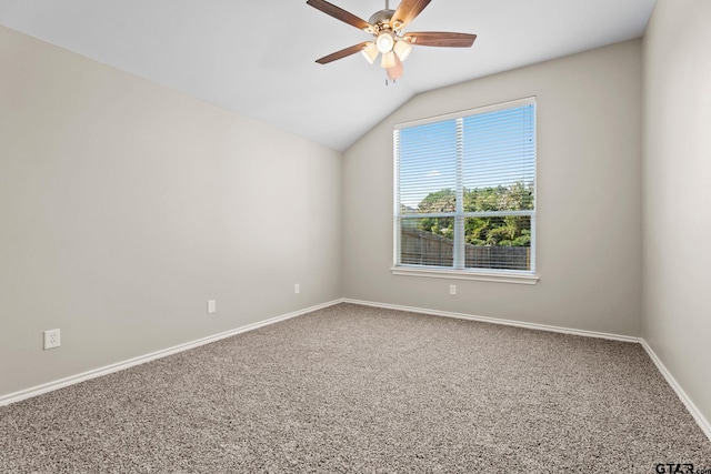 unfurnished room featuring ceiling fan, carpet, and vaulted ceiling