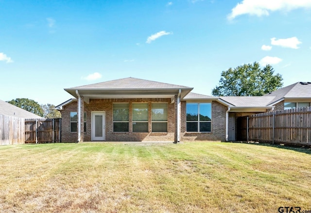 rear view of property featuring a yard