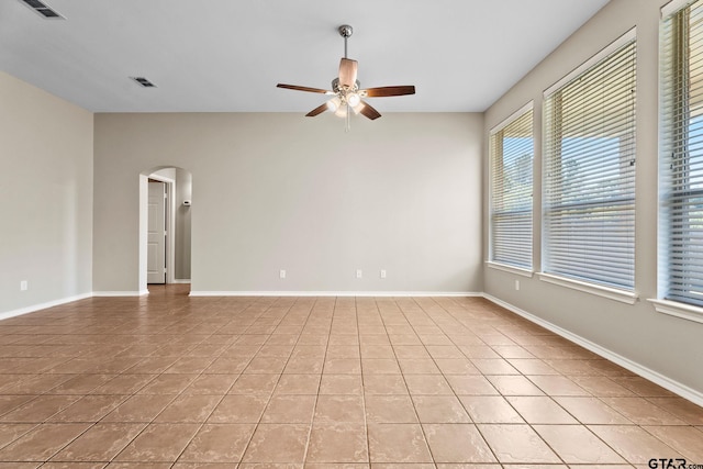 tiled empty room with ceiling fan