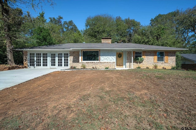 ranch-style house featuring french doors