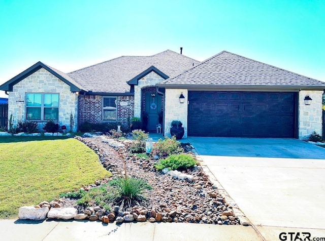 ranch-style house with a garage and a front yard