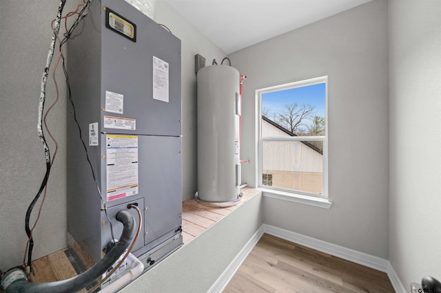 utility room with heating unit and water heater