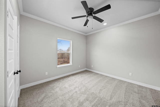 empty room featuring crown molding, carpet, and ceiling fan