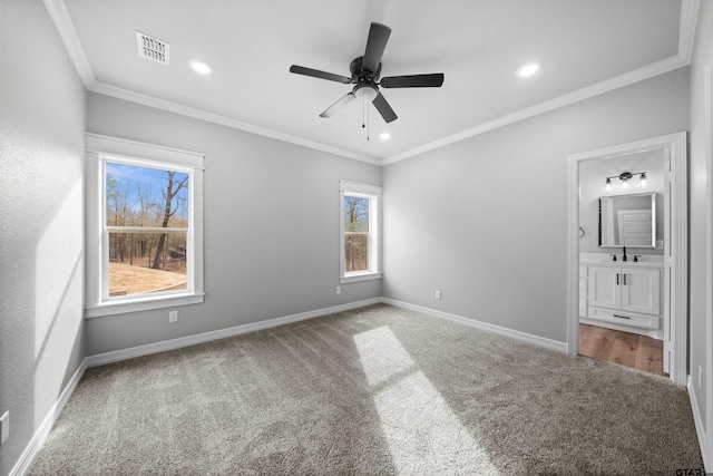 unfurnished bedroom with carpet flooring, ceiling fan, crown molding, and connected bathroom