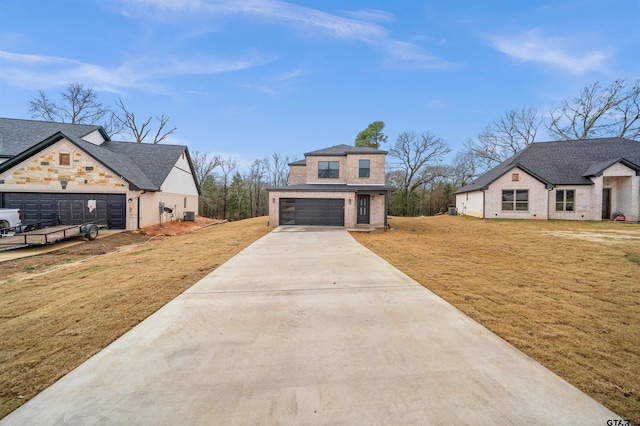 view of front of house featuring a front lawn and a garage