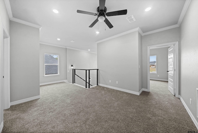 empty room featuring crown molding, ceiling fan, and light colored carpet