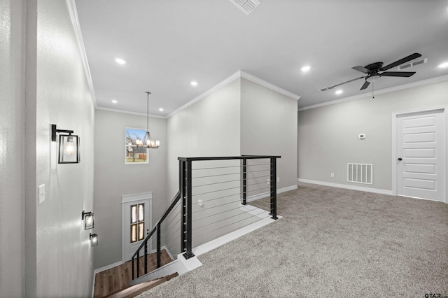 corridor featuring a chandelier, carpet floors, and ornamental molding