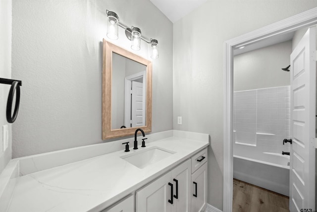 bathroom featuring vanity, wood-type flooring, and shower / bathtub combination