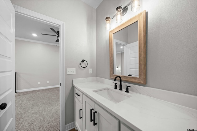 bathroom featuring vanity, ceiling fan, and crown molding