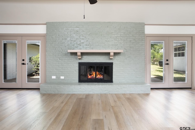 914 Neches Dr, Tyler, TX 75702 - unfurnished living room with french doors, wood finished floors, a fireplace, and ceiling fan