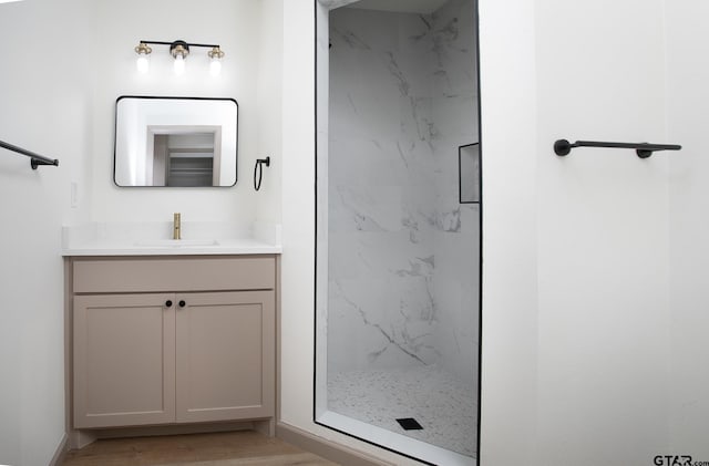 914 Neches Dr, Tyler, TX 75702 - bathroom featuring a marble finish shower, vanity, and wood finished floors