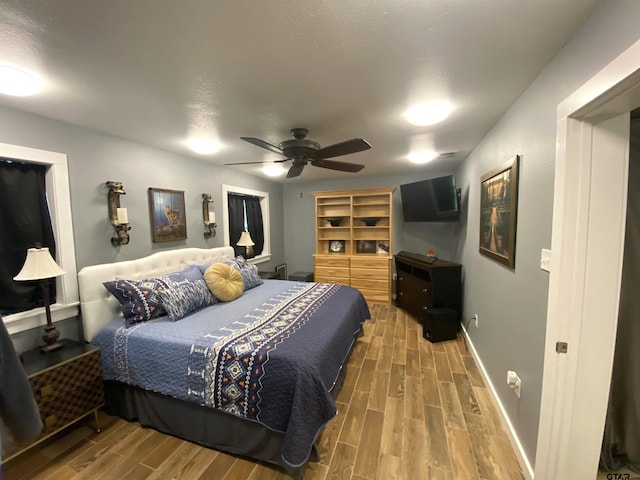 bedroom with hardwood / wood-style floors and ceiling fan