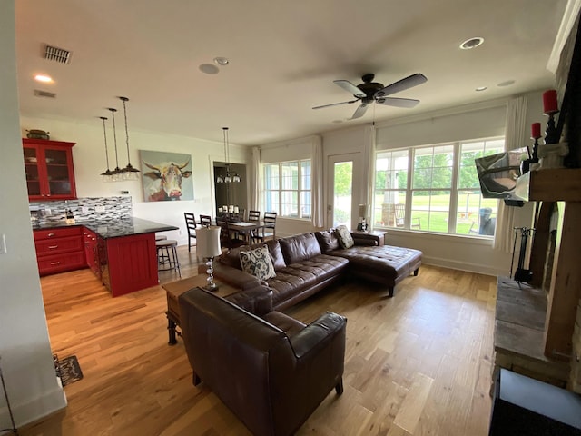 living room featuring light hardwood / wood-style floors and ceiling fan