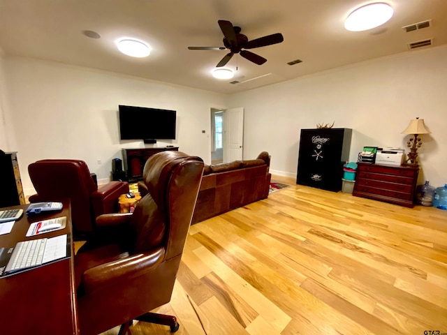 living room featuring ceiling fan and light hardwood / wood-style flooring