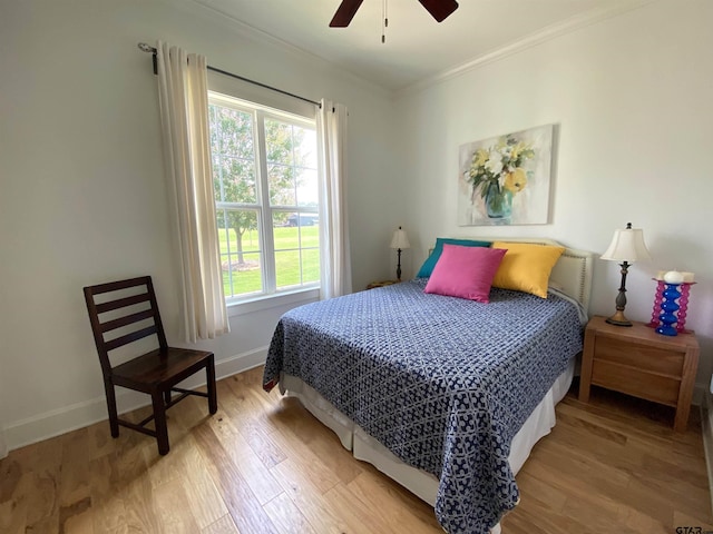 bedroom featuring ornamental molding, hardwood / wood-style floors, and ceiling fan