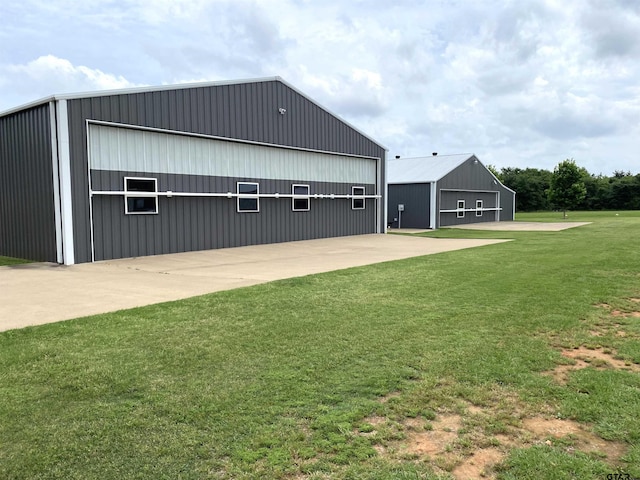 exterior space with a garage, a yard, and an outdoor structure