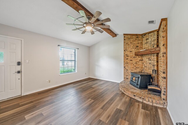 169 Phil Dr, Hawkins, TX 75765 - unfurnished living room with a wood stove, a ceiling fan, and wood finished floors