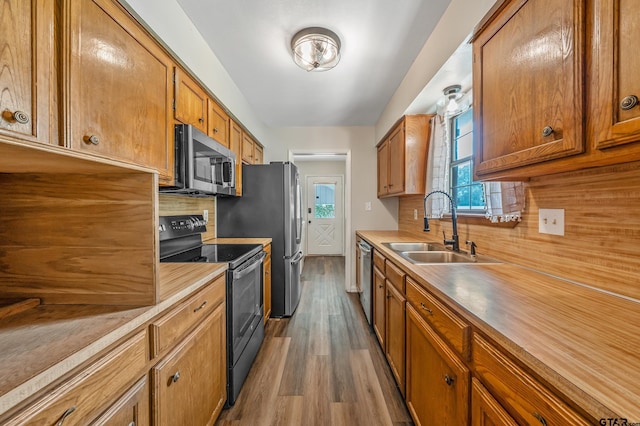 169 Phil Dr, Hawkins, TX 75765 - kitchen with stainless steel appliances, brown cabinets, dark wood-style floors, and decorative backsplash
