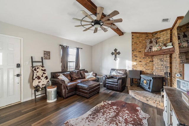 169 Phil Dr, Hawkins, TX 75765 - living room with ceiling fan, lofted ceiling with beams, dark hardwood / wood-style floors, and a wood stove